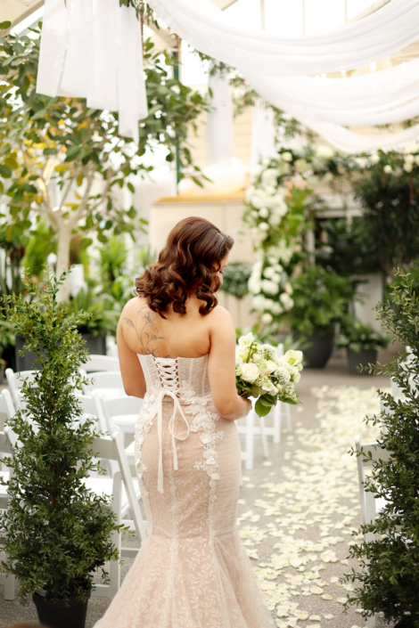 Bride walking down aisle with flowers